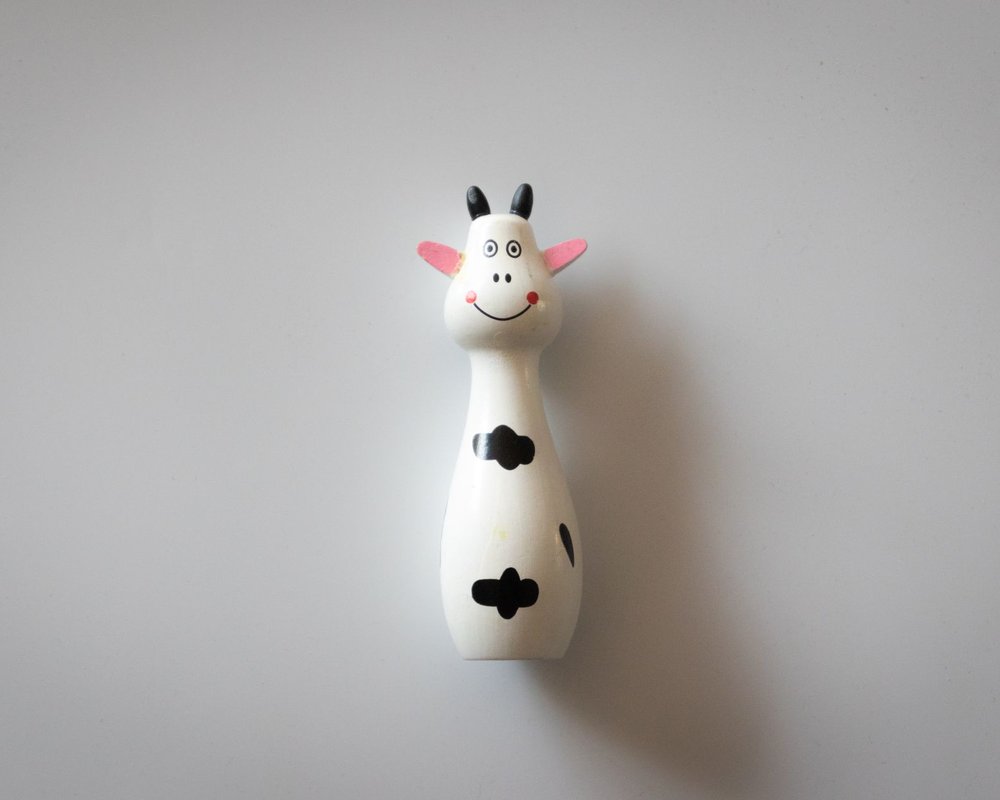 Hand-painted Swiss wooden cow figurine by Trauffer